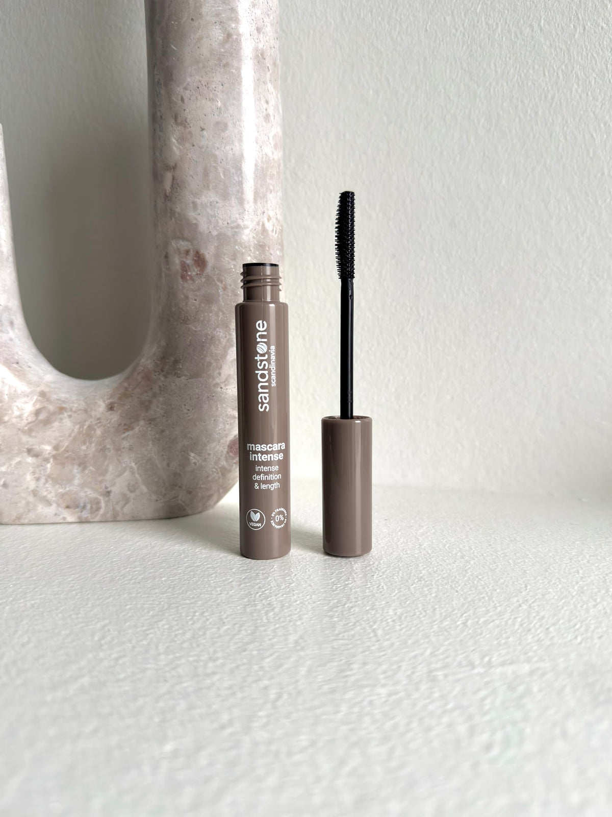 Sandstone Scandinavia model applying mascara illustrating comfortable wear