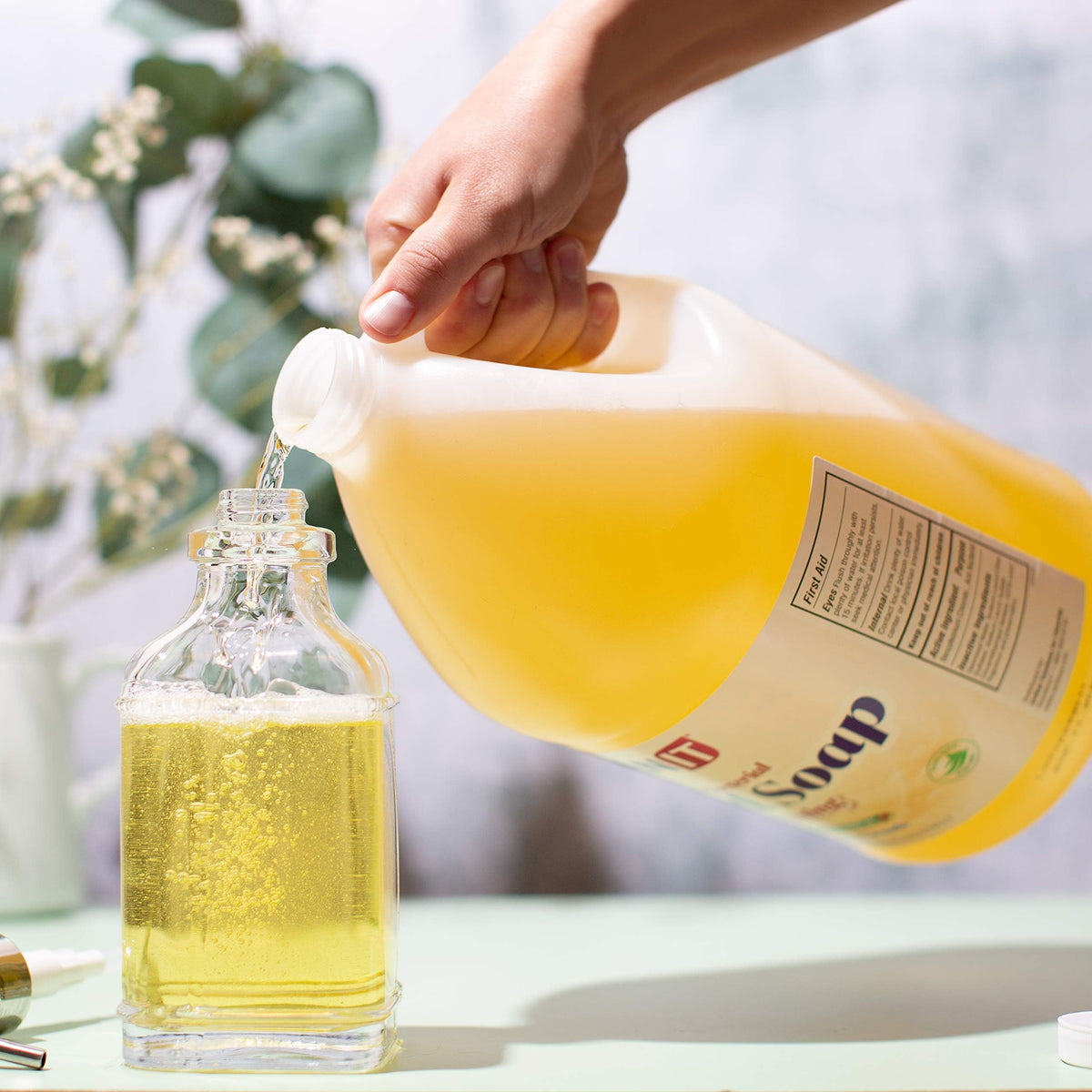 Sanit being poured into a foaming dispenser for economical refilling