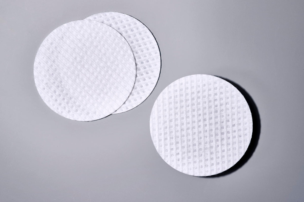 Sanitas jar next to coin showing compact travel-friendly size