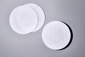 Sanitas jar next to coin showing compact travel-friendly size