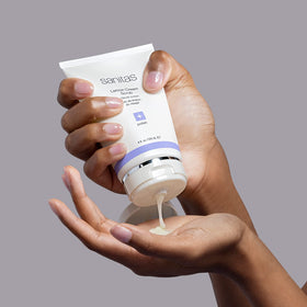 Sanitas scrub in hand demonstrating application and smooth glide for softer skin benefit