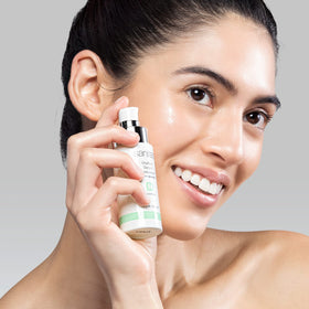 Sanitas hand applying serum to jawline showing easy layering and quick absorption