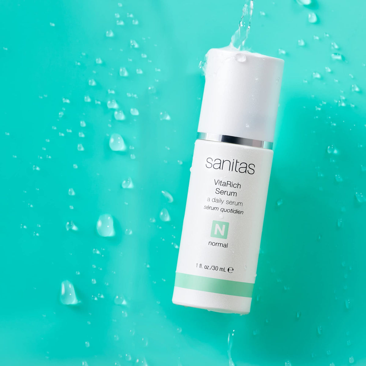 Sanitas close-up of serum texture on fingertip demonstrating lightweight absorbency