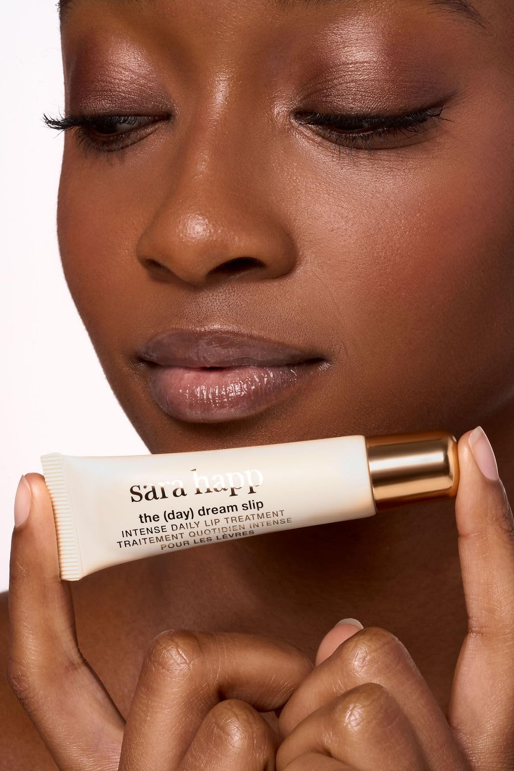 Product being applied from tube in hand illustrating convenient, mess-free use and protection