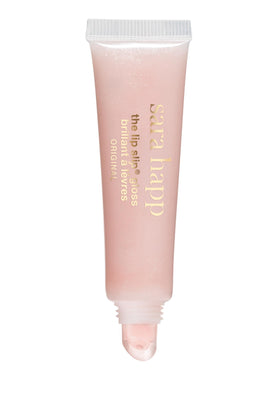 Sara Happ gloss on vanity with flowers showing luxury scent and everyday elegance benefit