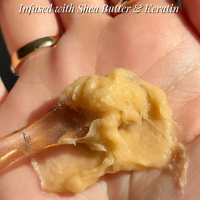 Savannah Hair Therapy cream being applied on hands to demonstrate easy spread
