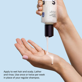SEEN shampoo held in hand for size comparison and travel convenience