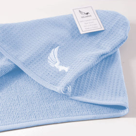 SELARUS towel next to a hand showing scale and ample coverage for long hair