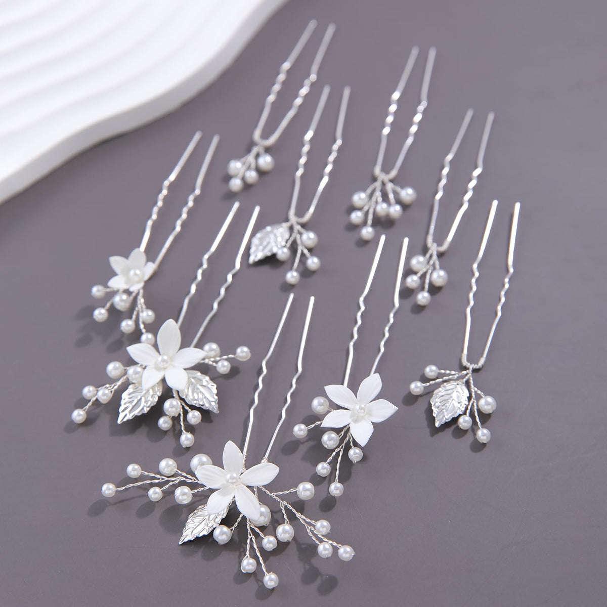 SELFCLOUD pins arranged in half-up hairstyle adding pearl accents and refined look