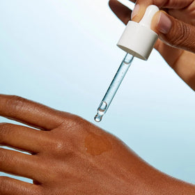 Senté serum layered under moisturizer, showing compatibility and smooth layering benefit