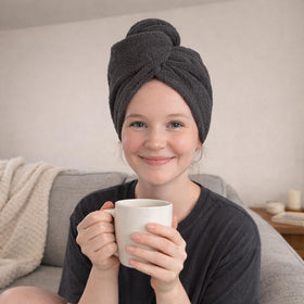 Seritaine towel next to shampoo and conditioner illustrating post-shower routine benefit