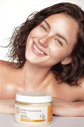 Spoonful of Shea Radiance melting on hand demonstrating easy spread and hydration