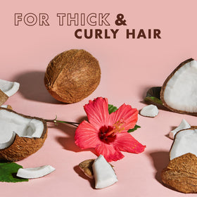 SheaMoisture in-use on wet curly hair showing frizz control and definition