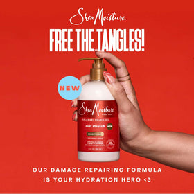 Shea Moisture refresher spray in hand misting hair to revive and reduce frizz