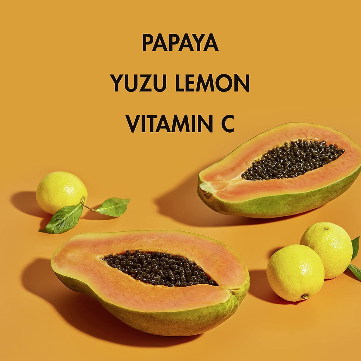 SheaMoisture papaya and yuzu slices beside bottle highlighting natural extracts