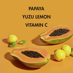 SheaMoisture papaya and yuzu slices beside bottle highlighting natural extracts