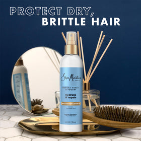 SheaMoisture bottle held in hand showing 8 oz scale and travel-friendly benefit