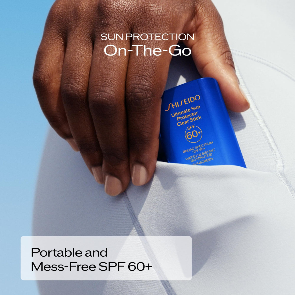 Shiseido stick beside hand to illustrate 60 g portable size and convenience