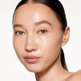 Shiseido foundation applied with brush on model cheek for natural luminous finish