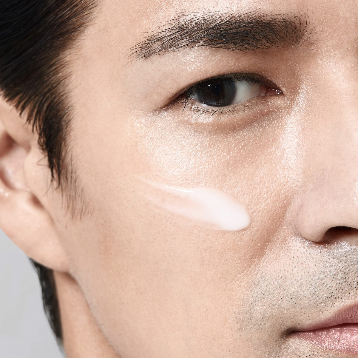 Shiseido men size and scale 100 mL bottle placed beside grooming items for value benefit