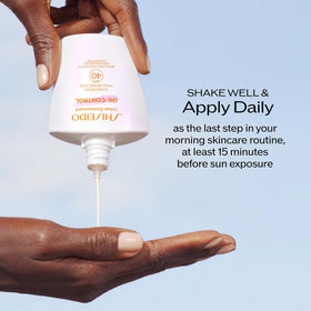 Shiseido bottle in outdoor scene indicating water resistance and active protection