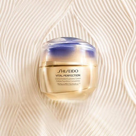 Shiseido 50 mL jar next to coin showing compact size and travel-friendly benefit