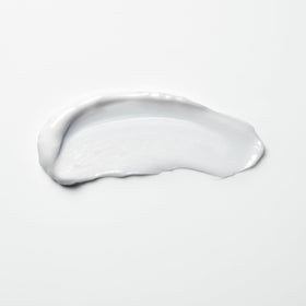 shu uemura art of hair bottle next to hand to show travel-size portability
