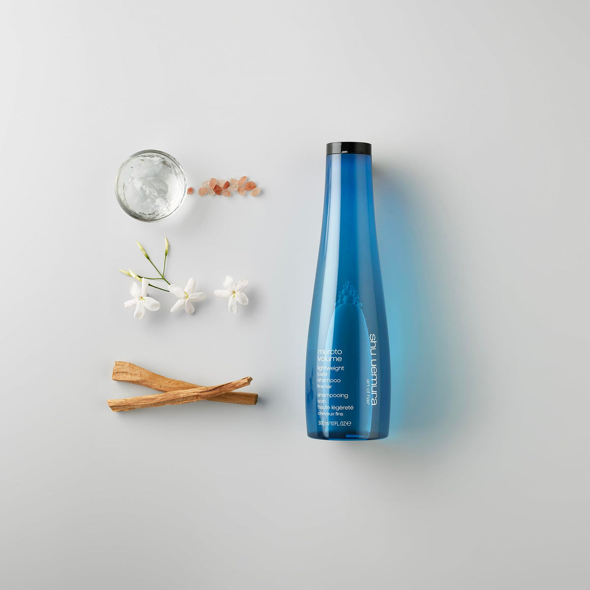 shu uemura 10 fl oz bottle next to common item showing true size and convenience