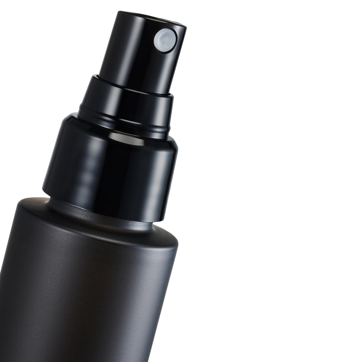 shu uemura model using mist outdoors showing long-lasting makeup benefit