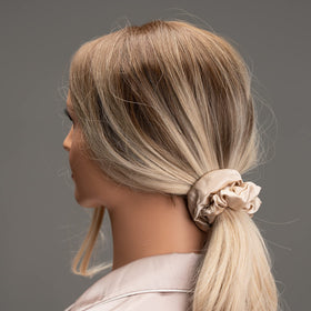 Silmer flatlay of pink, peacock blue, apricot scrunchies showcasing color variety