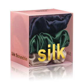 Silmer front packaging showing three silk scrunchies, highlighting luxury and color options