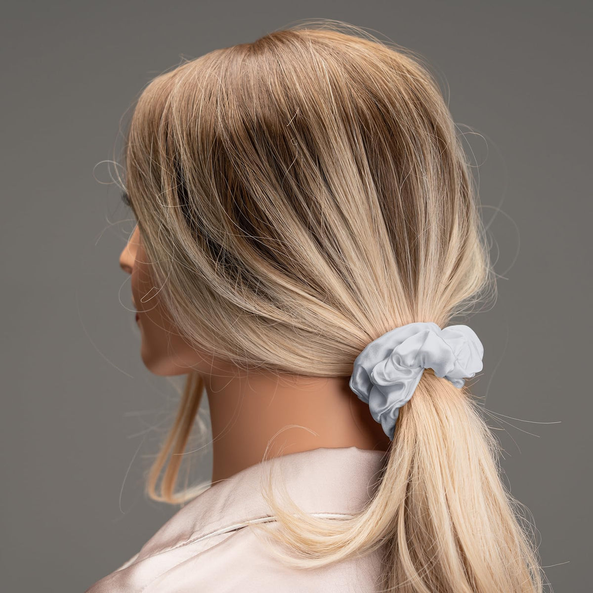 Silmer scrunchie securing a ponytail in dark gray offering strong gentle hold