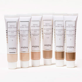 Sisley Paris bottle in hand showing 40 mL scale and travel-friendly benefit