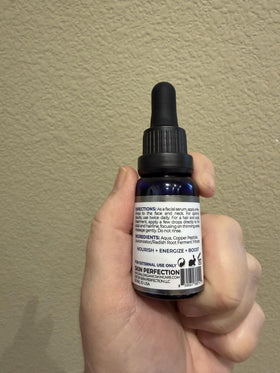 Skin Perfection cobalt bottle detail reflecting light and protecting active copper peptide