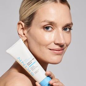 SKINN cleanser being applied to a wet face illustrating morning use