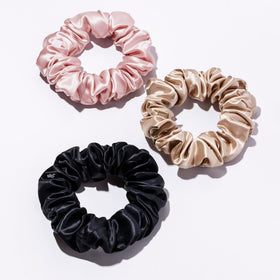 SLIP scrunchie held in hand to show large size and scale for thicker hair