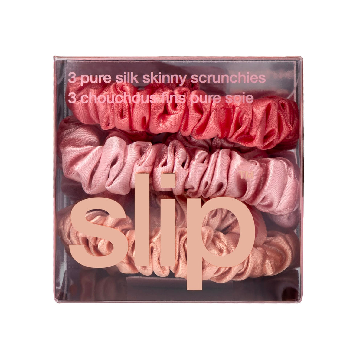 SLIP scrunchie held in hand to show slim size and travel convenience
