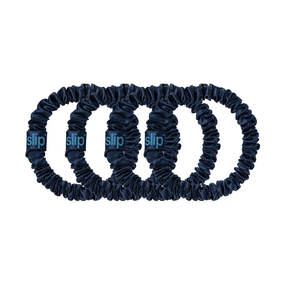 Slip scrunchie beside a ruler to show slim size and discreet profile