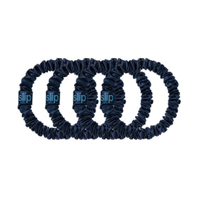 Slip scrunchie beside a ruler to show slim size and discreet profile