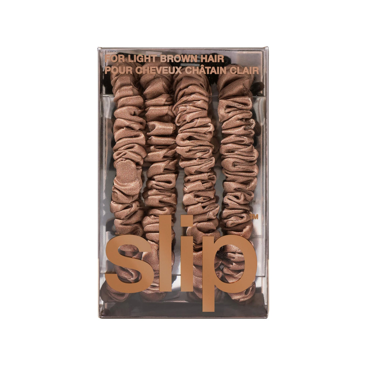 Slip scrunchie next to coin for scale, compact and travel-friendly benefit