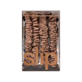 Slip scrunchie next to coin for scale, compact and travel-friendly benefit