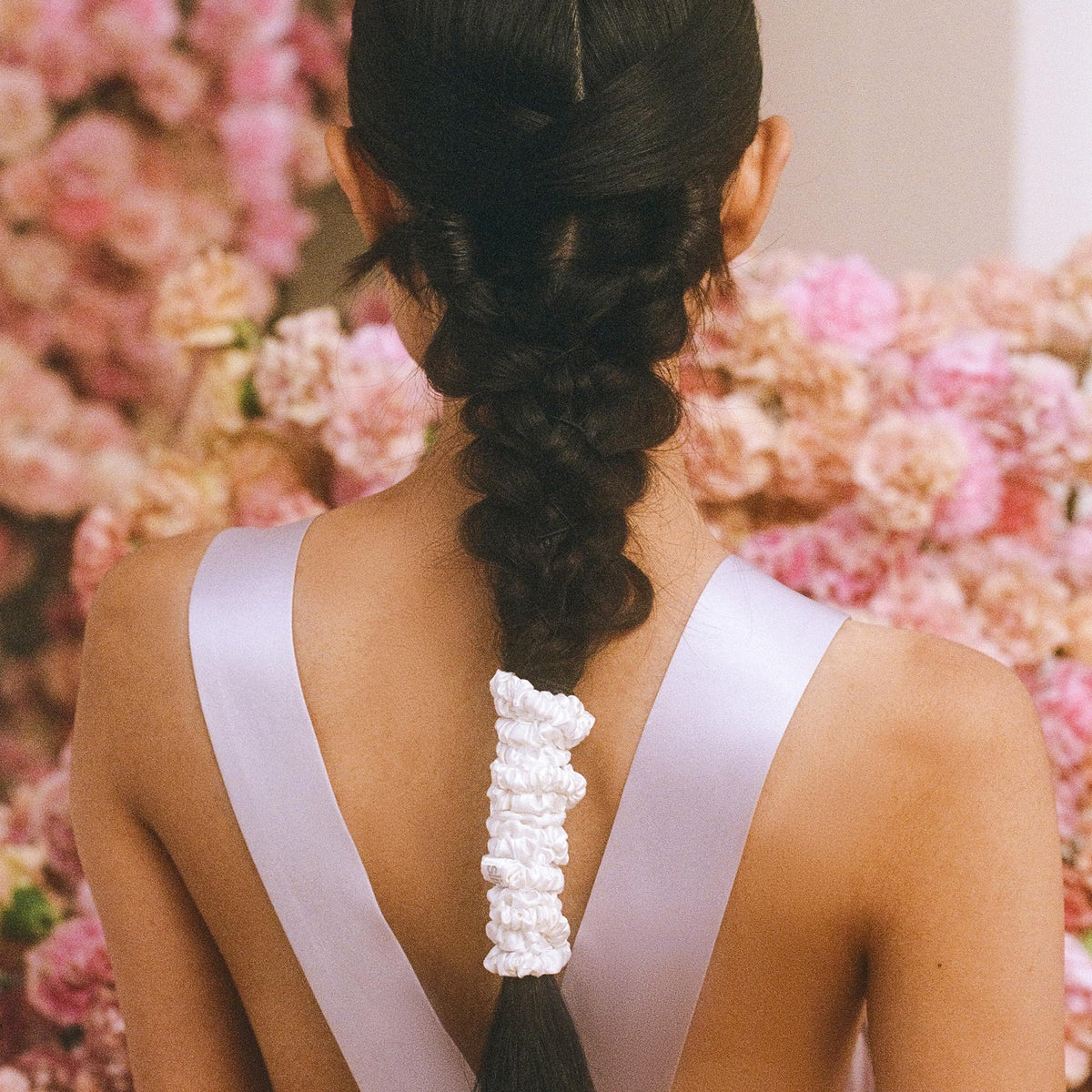 SLIP scrunchie beside ruler showing slim profile and lightweight design