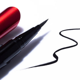 Smashbox eyeliner beside ruler showing size and 0.02 oz travel-friendly benefit
