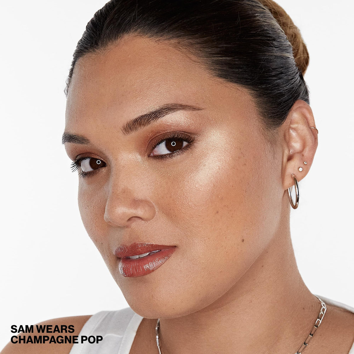 Smashbox x BECCA being applied to cheekbone showing immediate lifted radiance