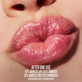 Sol de Janeiro lip butter held in hand to show size and convenient portability benefit