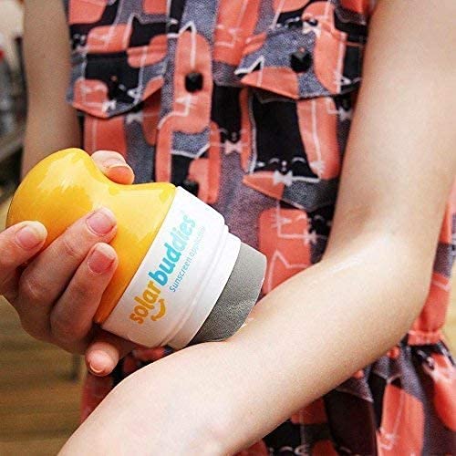 Solar Buddies applicator in use with child applying sunscreen easily at the beach
