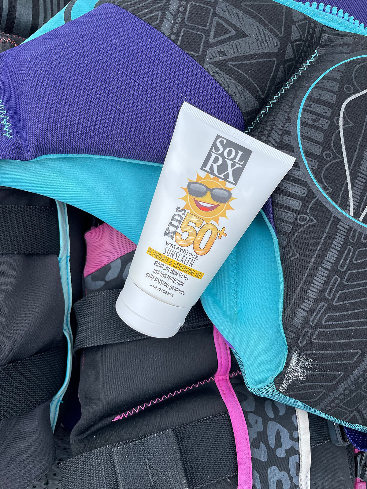 Child wearing SolRX at beach illustrating water-resistant protection