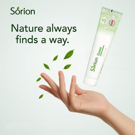 Sorion cream jar beside a hand for size scale and travel convenience
