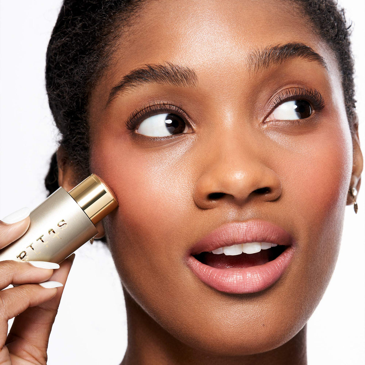 stila lifestyle image with stick in handbag, conveys quick touch-up readiness