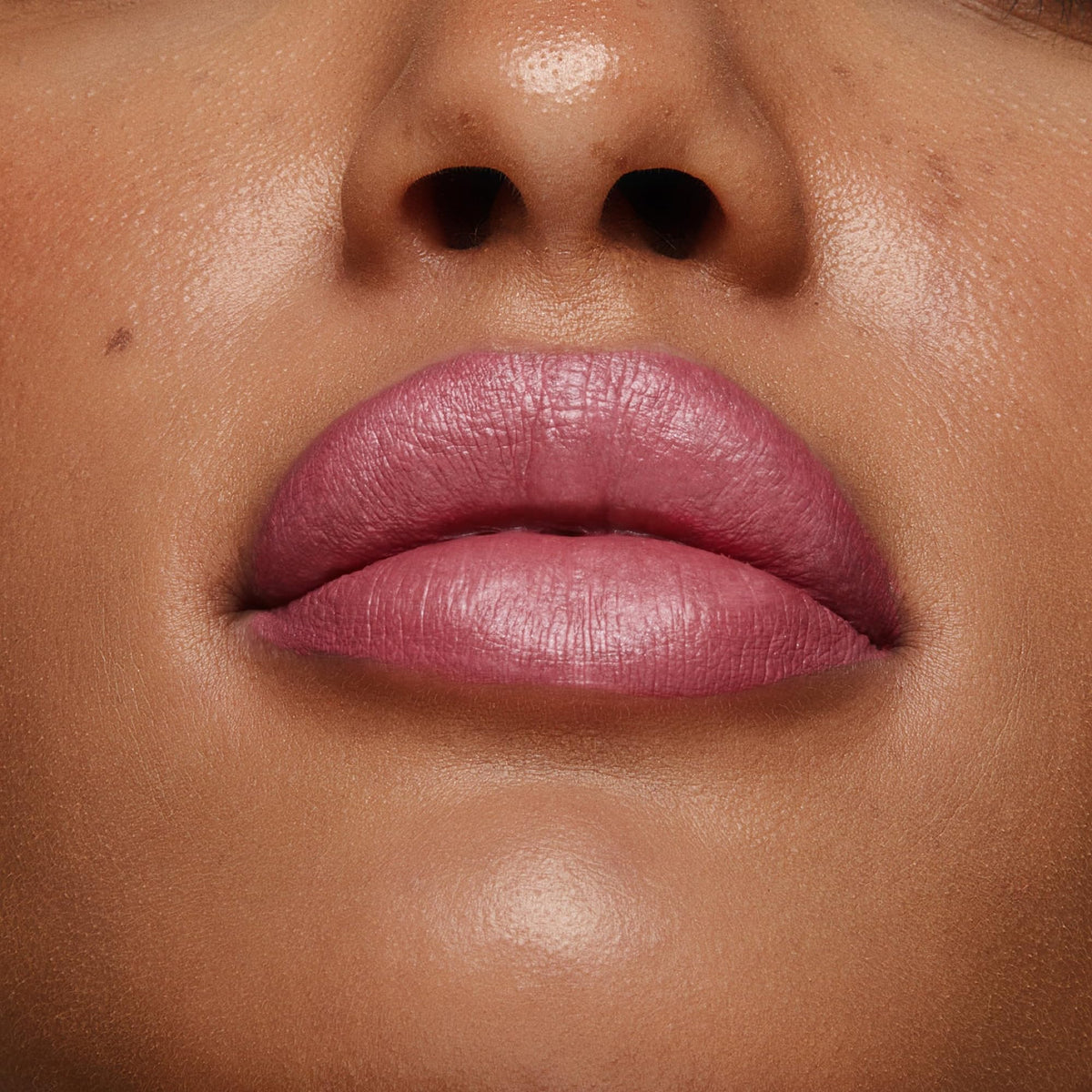 stila on model in evening setting showcasing long-wear shimmer for event-ready lips